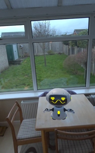 Tiny Ravi the helpful robot on a table in my conservatory